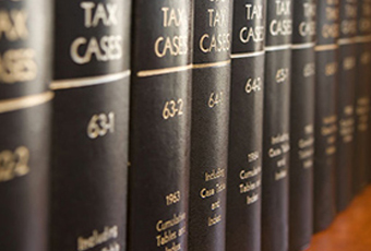 Tax case law books on a bookshelf
