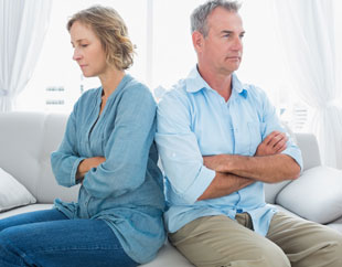 Older couple with their arms folded after an argument